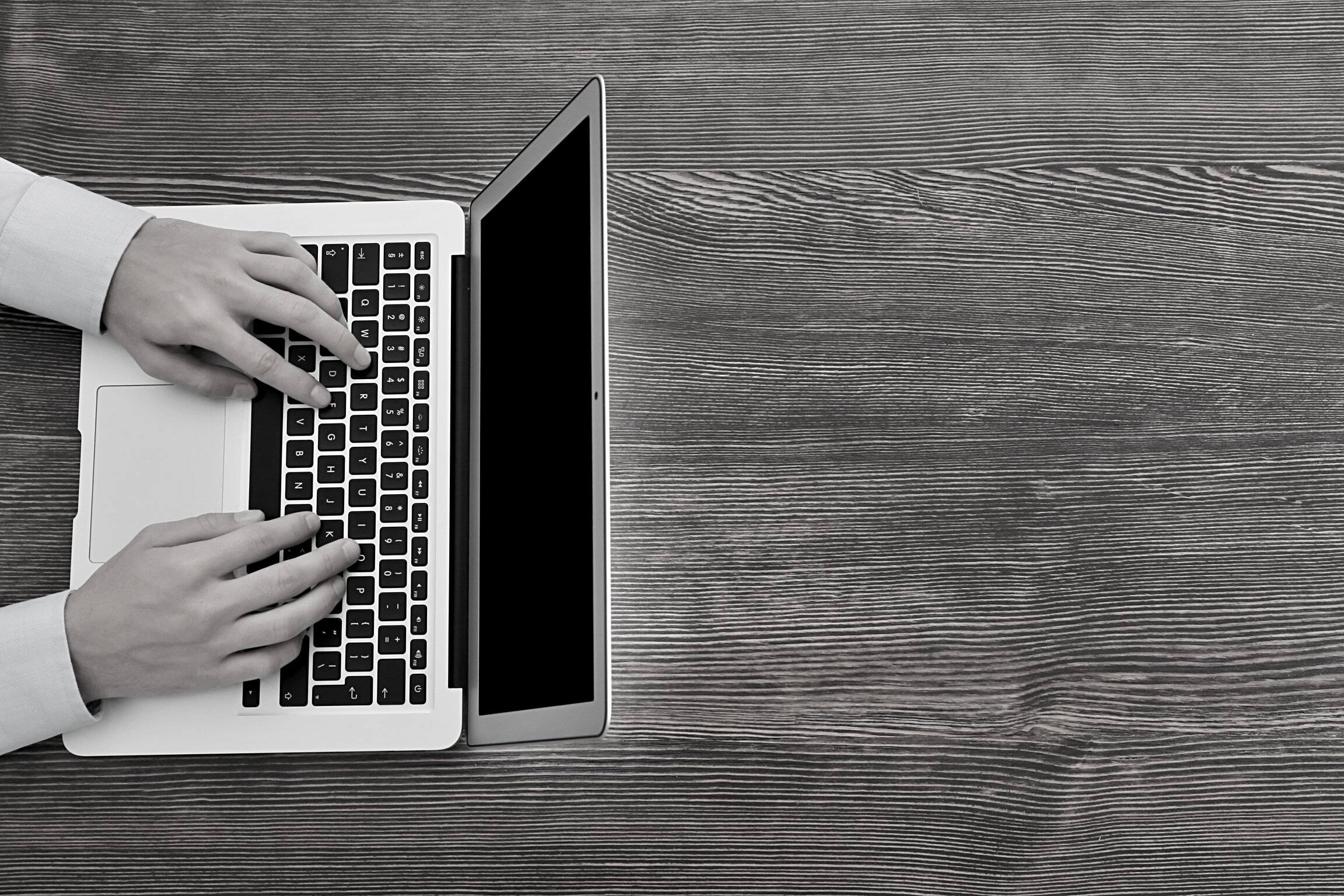 Marketing Manager Working with Laptop at Office Table